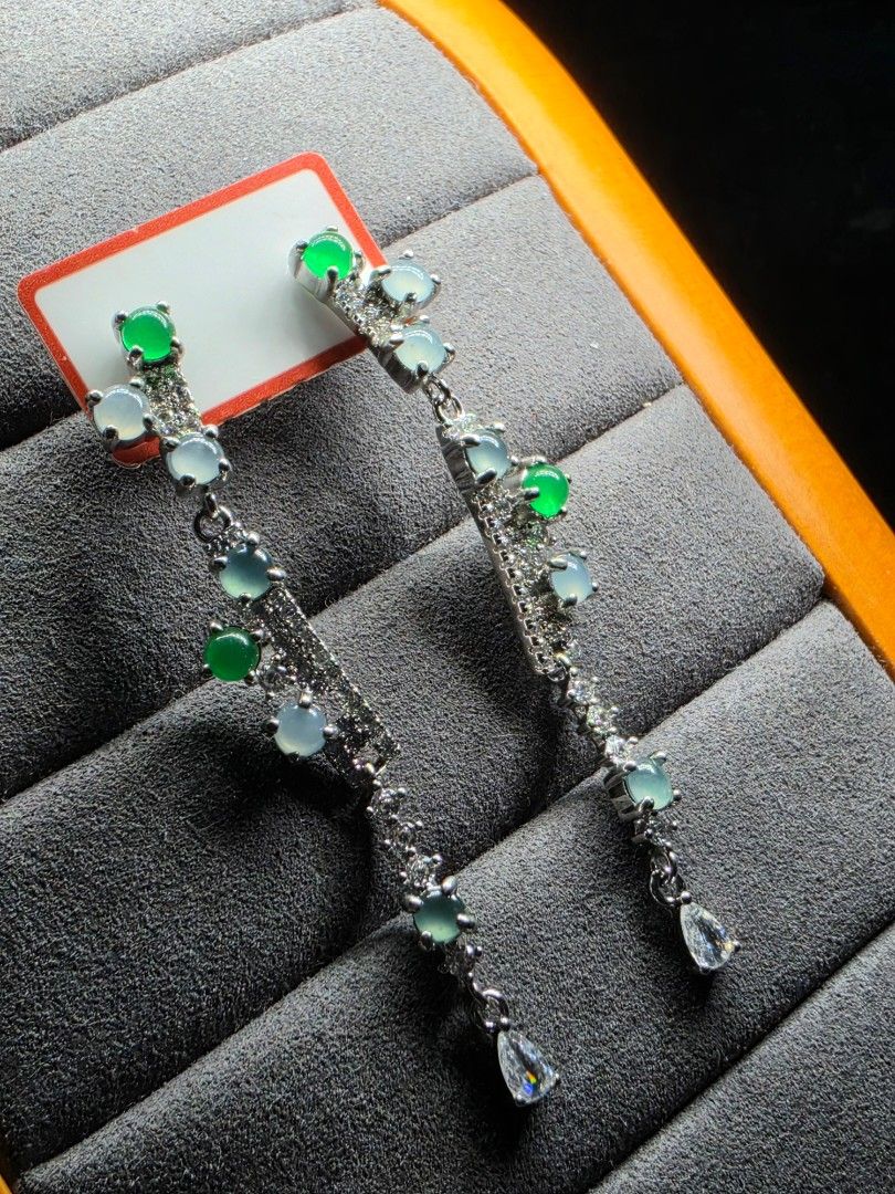 Natural Jadeite dangle earrings with green jade cabochons (Category: Earrings) located in Manila. Submitted by jadeitesph (Listing ID 1470866350, Image 1). Description: - Style: Long dangle drop earrings with post-back closure - Material: Silver-tone metal with sparkling pavé crystals - Stones: Multiple green and icy white jadeite cabochons in varying sizes - Detail: Finished with a chic teardrop crystal accent at the top - Condition: Brand new, 