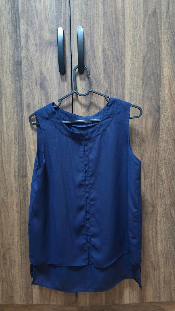 Navy Blue Sleeveless Layered Blouse (Category: Sleeveless) located in Manila. Submitted by stuff.gaming (Listing ID 1470804748, Image 2). Description: - Color: Navy Blue - Style: Sleeveless blouse with a chic layered hem and round neckline - Material: Lightweight, flowy, and easy-to-care-for fabric - Details: Clean stitching down the front - Versatility: Perfect for the office or dressed down with casual jeans Price still negotiable Shipping to b