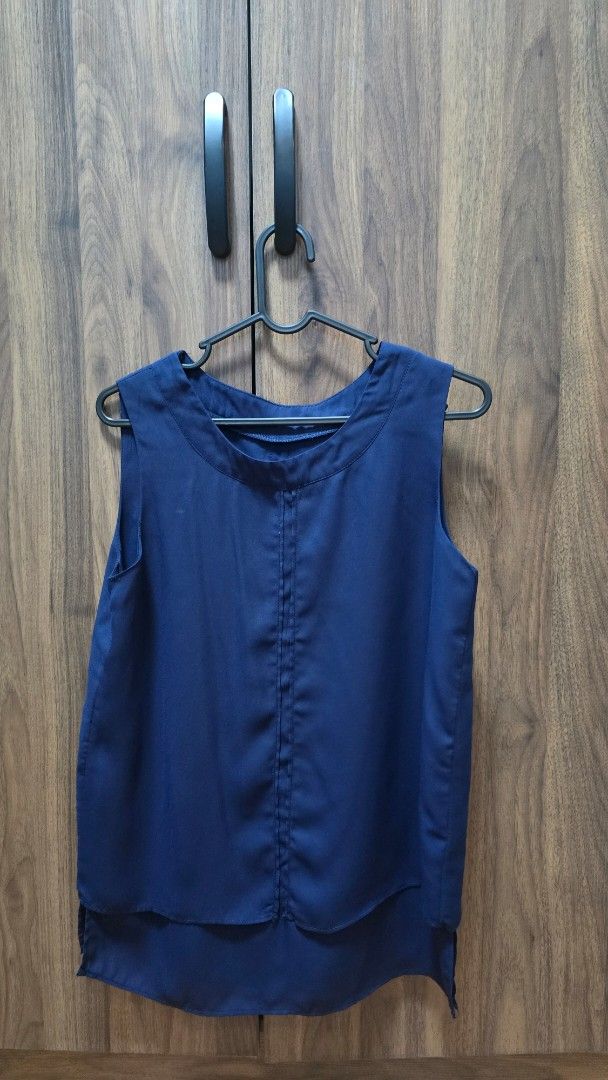 Navy Blue Sleeveless Layered Blouse (Category: Sleeveless) located in Manila. Submitted by stuff.gaming (Listing ID 1470804748, Image 1). Description: - Color: Navy Blue - Style: Sleeveless blouse with a chic layered hem and round neckline - Material: Lightweight, flowy, and easy-to-care-for fabric - Details: Clean stitching down the front - Versatility: Perfect for the office or dressed down with casual jeans Price still negotiable Shipping to b