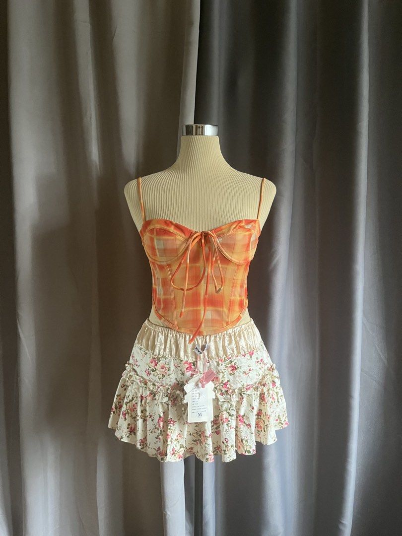 Neon Hart Orange Viccy Check Mesh Corset Cami Top (Category: Sleeveless) located in Cagayan de Oro. Submitted by curated_closetph (Listing ID 1470746607, Image 1). Description: — Size: XS - S — Color: Orange / Yellow Plaid — Lightweight sheer mesh overlay fabrication — Sweetheart neck with fixed thin cami straps — Front criss-cross tie detailing — Pointed asymmetrical hem — Exposed center back zipper closure — Can negotiate the price — 🛒 Shop mo