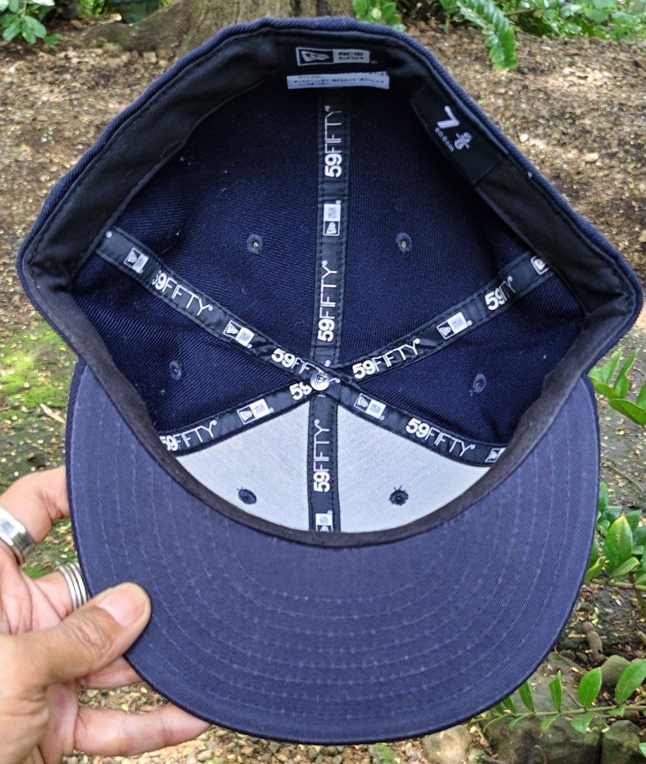 New Era 59FIFTY Navy Fitted Hat Size 7 5/8 (Category: Caps & Hats) located in Manila. Submitted by sansmerci27 (Listing ID 1470900368, Image 2). Description: - Brand: New Era 59FIFTY - Color: Navy blue with white outlined front logo - Size: 7 5/8 - Style: Structured crown with flat brim - Condition: Clean sweatband, interior taped seams, and original gold foil sticker on brim.