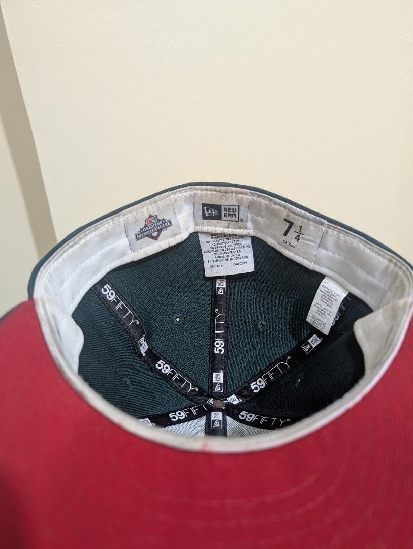 New Era Bisons Fitted Hat Size 7 1/4 (Category: Caps & Hats) located in Del Monte. Submitted by emman08255 (Listing ID 1470846490, Image 2). Description: - Brand: New Era 59FIFTY - Team: Buffalo Bisons (Embroidered front) - Color: Green and Red - Size: 7 1/4 (57.7 cm) - Material: 100% polyester, made in China - Condition: Clean structure overall with minor sweatband staining from wear.