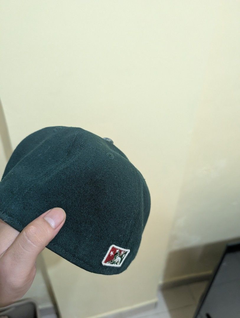 New Era Bisons Fitted Hat Size 7 1/4 (Category: Caps & Hats) located in Del Monte. Submitted by emman08255 (Listing ID 1470846490, Image 3). Description: - Brand: New Era 59FIFTY - Team: Buffalo Bisons (Embroidered front) - Color: Green and Red - Size: 7 1/4 (57.7 cm) - Material: 100% polyester, made in China - Condition: Clean structure overall with minor sweatband staining from wear.