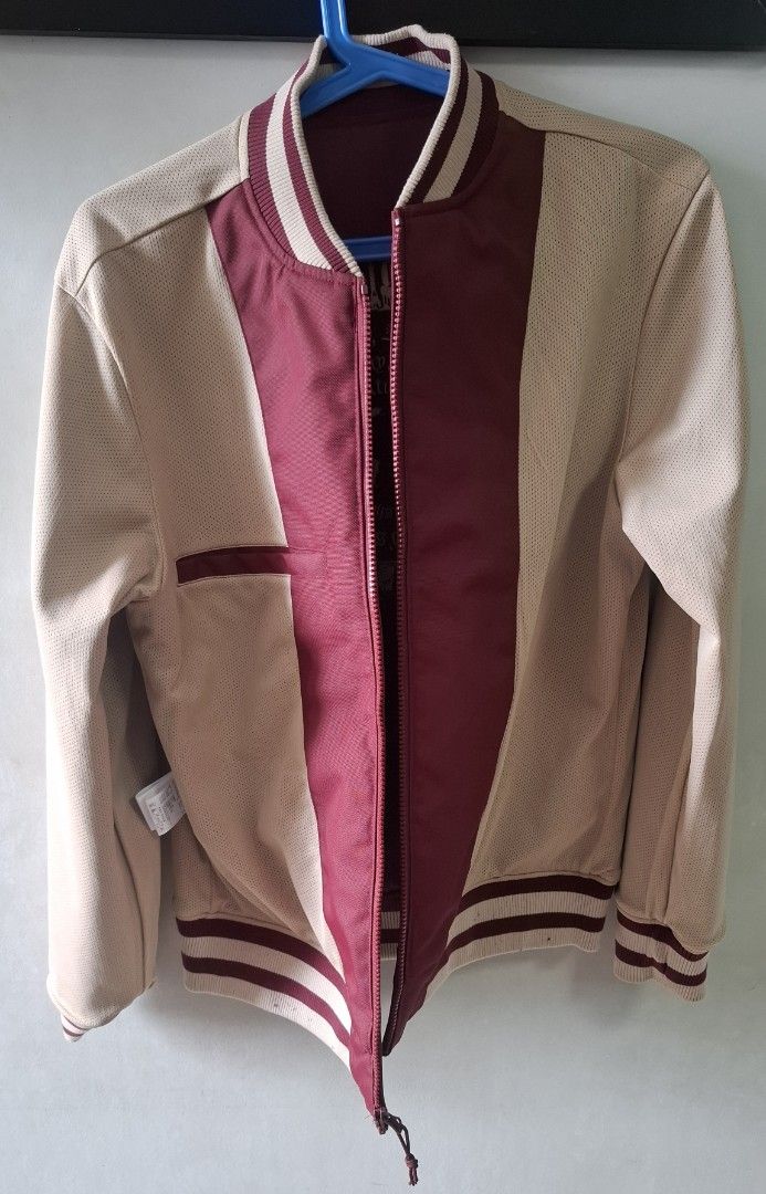 New Era Reversible Bomber Jacket Burgundy Beige Medium (Category: Coats, Jackets and Outerwear) located in Taguig. Submitted by atticusmerch (Listing ID 1470780153, Image 3). Description: Reversible bomber jacket from New Era. One side maroon with city names and globe graphic on back. Other side beige mesh with maroon center stripe. Zip front, striped ribbed collar, cuffs, and hem. Size medium based on tag. Clean condition overall, minimal wear..
