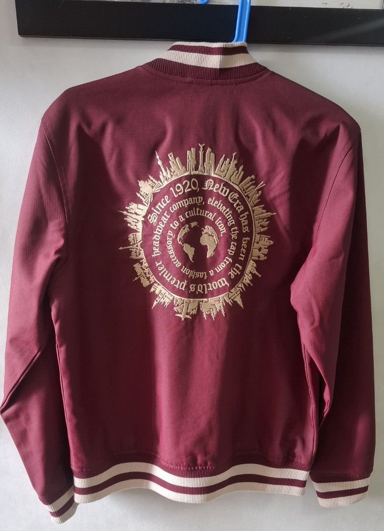 New Era Reversible Bomber Jacket Burgundy Beige Medium (Category: Coats, Jackets and Outerwear) located in Taguig. Submitted by atticusmerch (Listing ID 1470780153, Image 2). Description: Reversible bomber jacket from New Era. One side maroon with city names and globe graphic on back. Other side beige mesh with maroon center stripe. Zip front, striped ribbed collar, cuffs, and hem. Size medium based on tag. Clean condition overall, minimal wear..