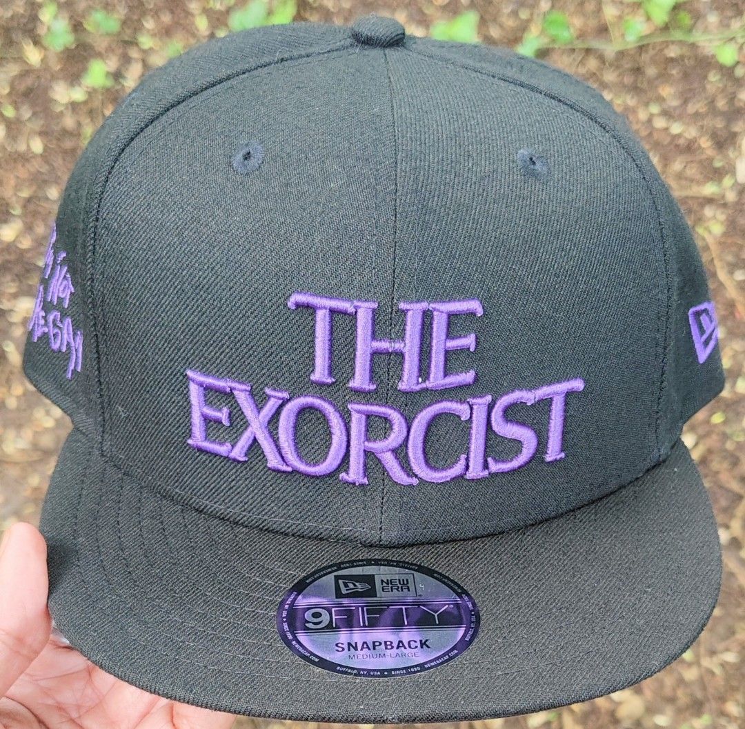 New Era The Exorcist 9Fifty Snapback Cap (Category: Caps & Hats) located in Manila. Submitted by sansmerci27 (Listing ID 1470903160, Image 1). Description: Black New Era 9FIFTY snapback cap featuring embroidered purple text of The Exorcist on the front and 'I'm Not Regan' on the side. Under-brim and interior lining feature a graphic print of Regan from the movie. Adjustable snapback closure at the back. Flat brim with original sticker still attac