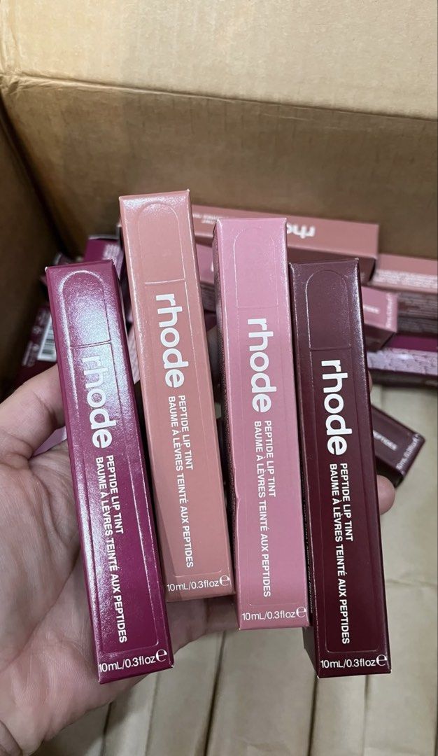 (new formula) Rhode Peptide Lip Tint (Category: Makeup) located in Leyte. Submitted by modernpersephone (Listing ID 1470827879, Image 1). Description: - 100% Brand new and unopened stock straight from the carton - Size: 10ml per tube - Highly hydrating peptide formula, perfect for everyday wear - Available in a variety of gorgeous shades - Buy your favorite color or collect the whole set today! Toast, Raspberry jelly, Ribbon, Espresso.