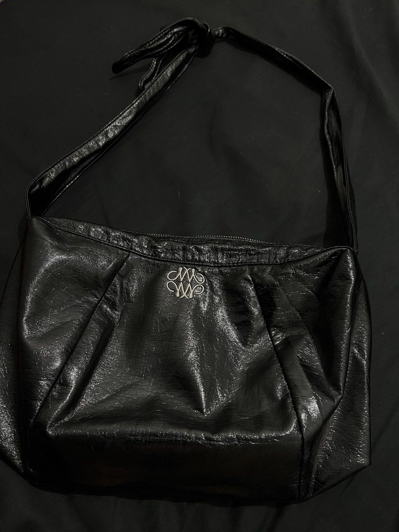 NICK NICOLE Black Crinkled Shoulder Bag (Category: Shoulder Bags) located in Manila. Submitted by h.p_virgoni (Listing ID 1470855929, Image 3). Description: - Brand: NICK NICOLE - Material: Black crinkled faux leather - Hardware: Silver-tone details - Closure: Secure top zip - Interior: Includes a zippered pocket with brand tag - Design: Front decorative branding embroidery and crinkled texture finish - Style: Shoulder bag with attached strap.