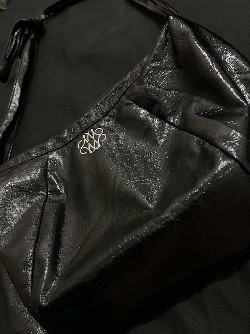 NICK NICOLE Black Crinkled Shoulder Bag (Category: Shoulder Bags) located in Manila. Submitted by h.p_virgoni (Listing ID 1470855929, Image 1). Description: - Brand: NICK NICOLE - Material: Black crinkled faux leather - Hardware: Silver-tone details - Closure: Secure top zip - Interior: Includes a zippered pocket with brand tag - Design: Front decorative branding embroidery and crinkled texture finish - Style: Shoulder bag with attached strap.