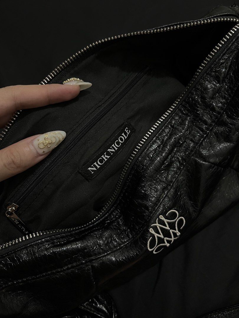 NICK NICOLE Black Crinkled Shoulder Bag (Category: Shoulder Bags) located in Manila. Submitted by h.p_virgoni (Listing ID 1470855929, Image 2). Description: - Brand: NICK NICOLE - Material: Black crinkled faux leather - Hardware: Silver-tone details - Closure: Secure top zip - Interior: Includes a zippered pocket with brand tag - Design: Front decorative branding embroidery and crinkled texture finish - Style: Shoulder bag with attached strap.