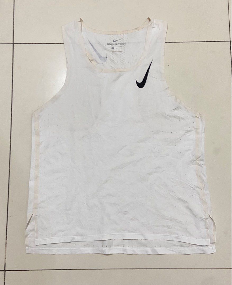 Nike AeroSwift Running Singlet White Men's Size L (Category: Activewear) located in Calumpit. Submitted by Ketchi (Listing ID 1470897790, Image 1). Description: - Brand: Nike AeroSwift - Color: White with black Swoosh logos on chest and back - Size: Large - Material: Breathable mesh fabric for optimal performance - Details: Printed neck label, sleeveless athletic top - Origin: Made in Cambodia Dimes: 25x18.5.
