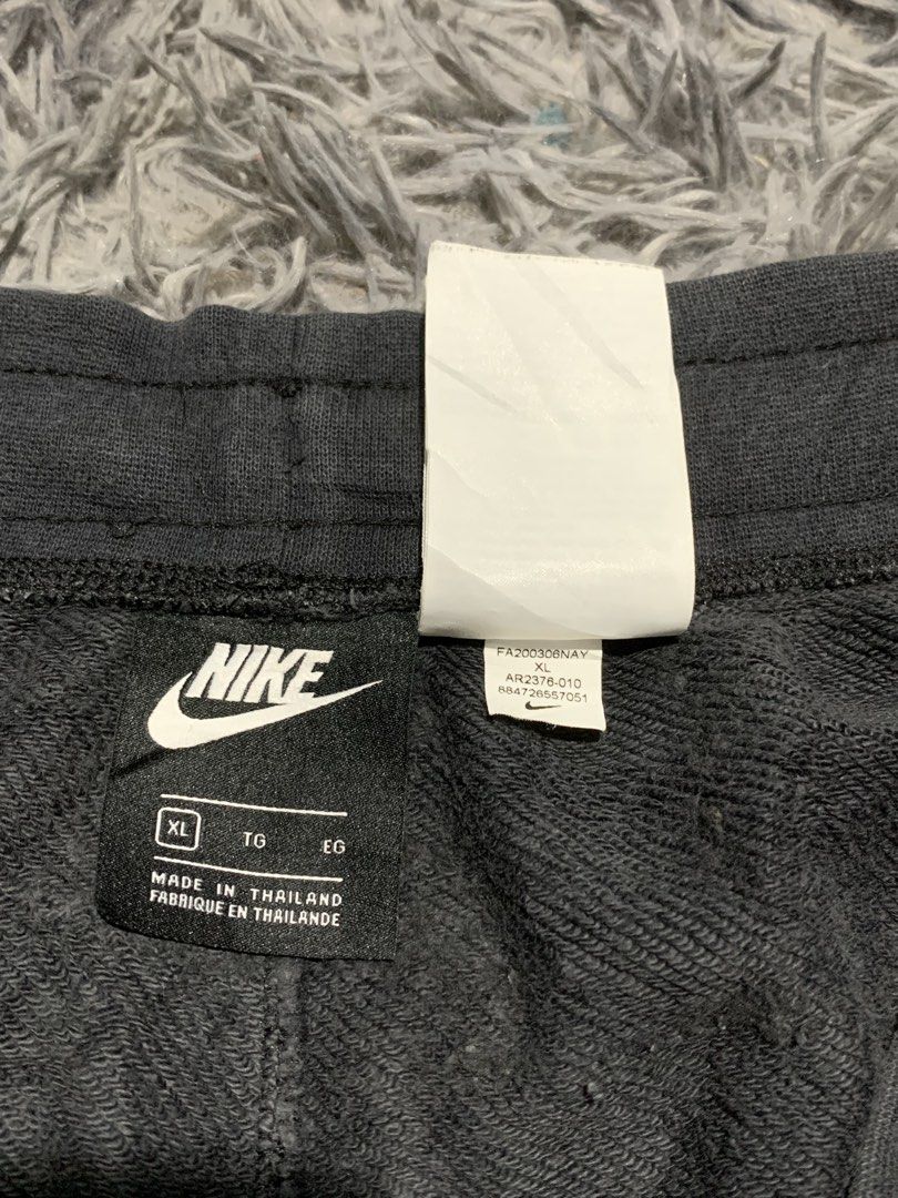Nike Alumni Black Sweatshorts (Category: Shorts) located in Tayug. Submitted by cvcthrift (Listing ID 1470897584, Image 3). Description: W-33-38 L-20 VGUC CR-9/10 - Brand: Nike - Item: Sweatshorts - Color: Black with large white Nike swoosh and logo on left leg - Size: XL - Material: 58% cotton, 25% rayon body; 100% cotton pockets - Features: Adjustable drawstring waistband with white cords - Origin: Made in Thailand - Style Code: AR2376-010.
