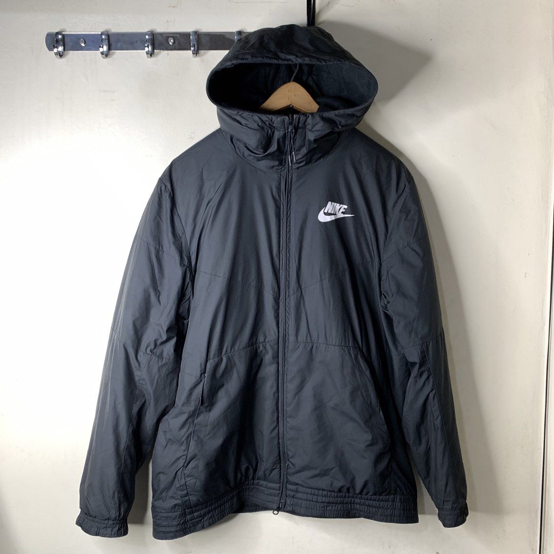Nike Black Hooded Jacket Windbreaker Size M (Category: Coats, Jackets and Outerwear) located in Imus. Submitted by la.wigginss0 (Listing ID 1470810214, Image 1). Description: - Brand: Nike - Color: Classic Black with White Chest Logo - Size: Medium (Tag on collar) - Material & Comfort: Soft fleece lining inside the hood and collar, lightweight yet warm - Design: Full zip closure, adjustable drawstring hood, elastic cuffs and hem - Origin: Made in