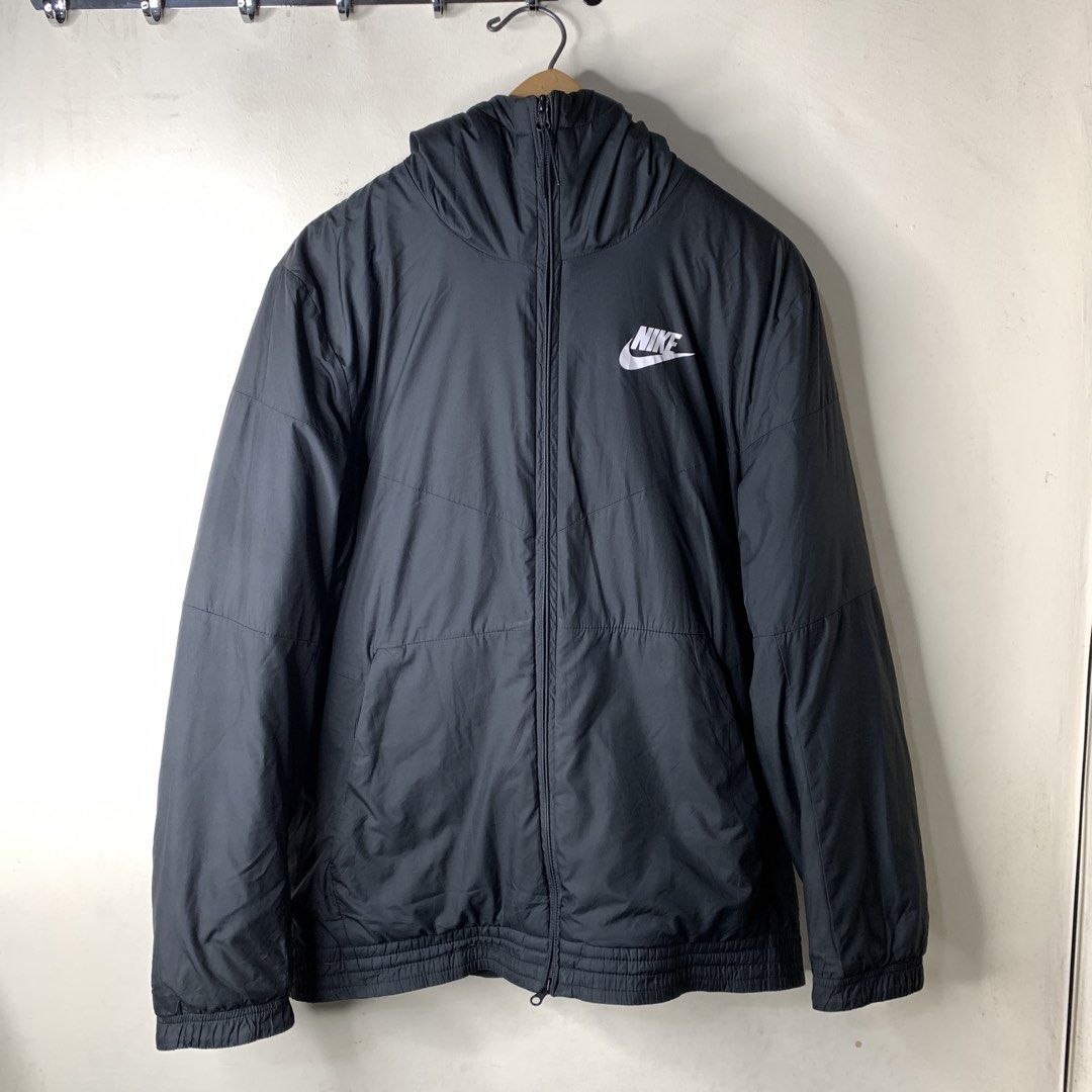Nike Black Hooded Jacket Windbreaker Size M (Category: Coats, Jackets and Outerwear) located in Imus. Submitted by la.wigginss0 (Listing ID 1470810214, Image 2). Description: - Brand: Nike - Color: Classic Black with White Chest Logo - Size: Medium (Tag on collar) - Material & Comfort: Soft fleece lining inside the hood and collar, lightweight yet warm - Design: Full zip closure, adjustable drawstring hood, elastic cuffs and hem - Origin: Made in