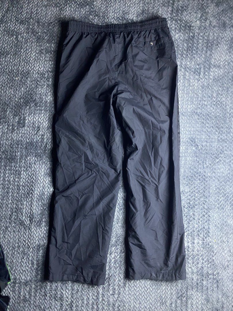 Nike Black Windbreaker Pants Size XL (Category: Joggers) located in Olongapo. Submitted by WAVYT (Listing ID 1470893621, Image 3). Description: - Brand: Nike - Item: Windbreaker Pants - Color: Black with white accents - Size: XL - Details: Embroidered white swoosh on left thigh, stylish side stripes down both legs - Comfort & Fit: Elastic waistband with adjustable white drawstring and breathable mesh lining - Storage: Functional back pocket with 