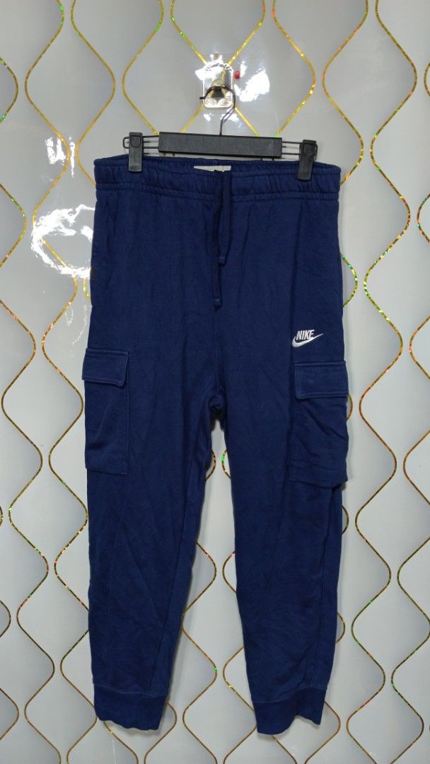 Nike Blue Cargo Sweatpants (Category: Joggers) located in Manila. Submitted by zariyah.1986 (Listing ID 1470795110, Image 1). Description: - Brand: Nike - Style: Cargo sweatpants with utility pockets on both legs - Color: Blue with embroidered white Nike logo on the left thigh - Size: L (Product code: CZ9955-410) - Features: Adjustable drawstring waistband and elastic ankle cuffs - Origin: Made in China - Condition: Great for casual wear and dail