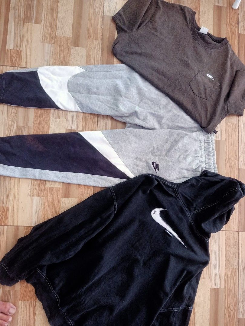 Nike Bundle Tee Sweatpants Hoodie (Category: Activewear) located in Manila. Submitted by aguilar.1993 (Listing ID 1470914810, Image 1). Description: - Brand: Nike - Bundle includes: Brown pocket t-shirt, grey multi-color panel joggers, and black hoodie with large white swoosh logo - Style: Streetwear mix, easy to mix and match - Versatile: Great for casual days or workouts.