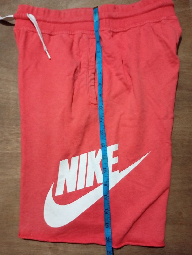 Nike Coral Sweat Shorts Size M (Category: Shorts) located in Muntinlupa City. Submitted by thriftsmuntinlupa26 (Listing ID 1470877824, Image 3). Description: - Brand: Nike - Color: Bright coral - Size: M (approx. 20 inches total length) - Details: Large white logo on left leg, elastic waistband with white drawstring cords, two side pockets - Condition: Great casual wear piece - Origin: Made in China.