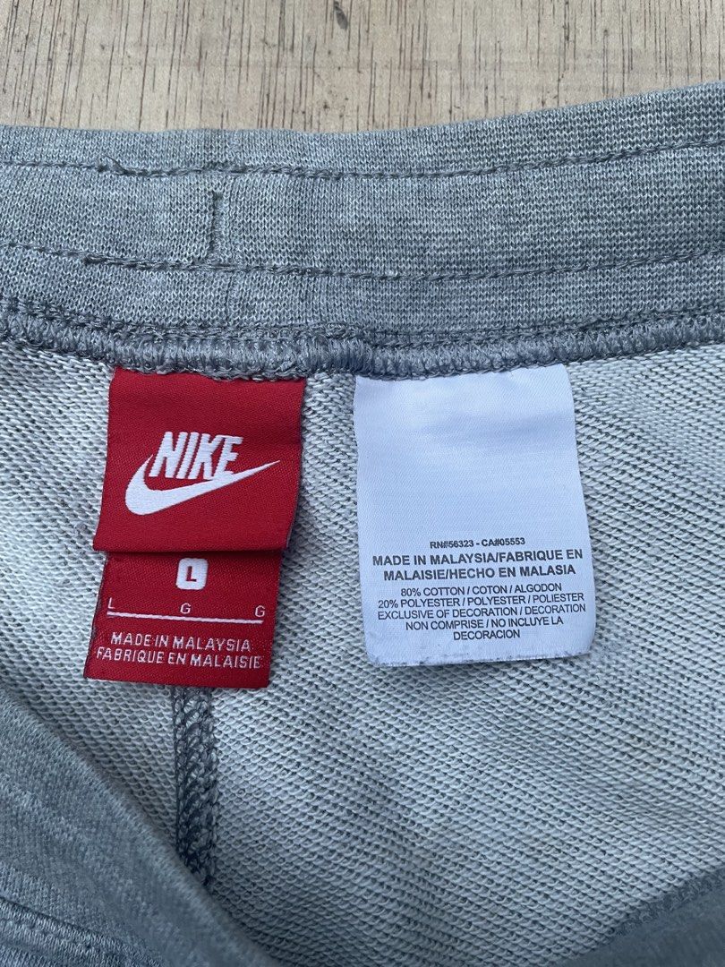 Nike Grey Cotton Fleece Shorts (Category: Shorts) located in Cebu City. Submitted by pinoclifford (Listing ID 1470834956, Image 3). Description: - Brand: Nike - Item: Grey shorts with black graphic logo - Size: Large (L) - Material: 80% Cotton, 20% Polyester - Features: Adjustable drawstring waistband and two functional side pockets - Origin: Made in Malaysia - Style Code: 728206-063 - Condition: Excellent.