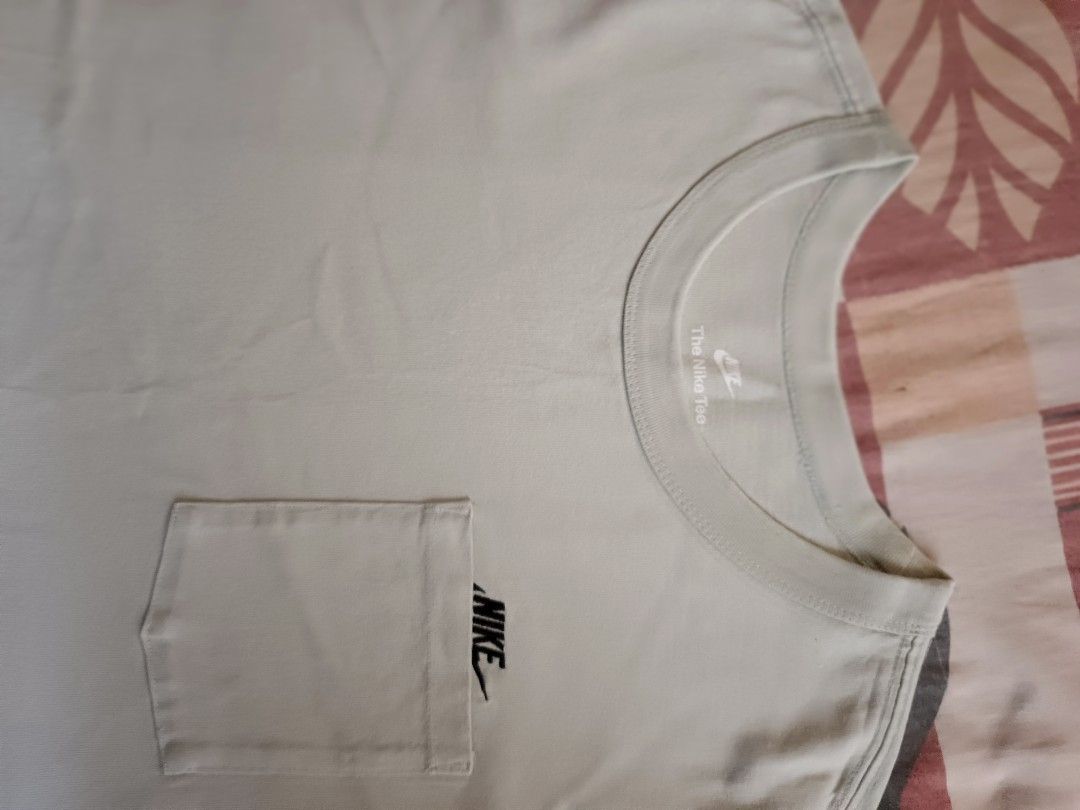 Nike pocket tee shirt (Category: Activewear) located in Odiongan. Submitted by thriftngo26 (Listing ID 1470759008, Image 2). Description: This item is the Nike Sportswear Premium Essentials Pocket T-Shirt in the "Seafoam" / "Jade Aura" colorway (Style Code: DQ9295-017 / FN3705-017). It is a heavyweight cotton tee featuring a roomy, loose fit and a signature chest pocket that partially covers the embroidered Nike Futura logo..