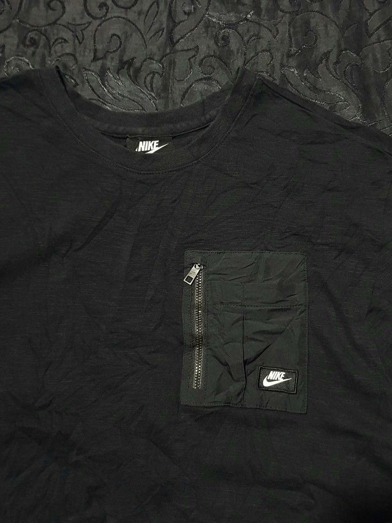 Nike Pocket T-Shirt Black (Category: Tshirts & Polo Shirts ) located in Manila. Submitted by tristan12_13 (Listing ID 1470891260, Image 2). Description: - Brand: Nike - Style: Utility tee with zippered left chest pocket and white logo patch - Size: XL on tag Dimensions: Width- 21 / Length- 29 - Color: Black - Material: Comfortable cotton blend - Fit: Standard crew neck - Product Code: CJ4324-010 - Condition: Brand new / Excellent everyday wear.