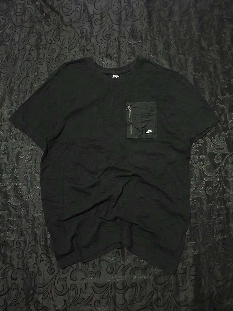 Nike Pocket T-Shirt Black (Category: Tshirts & Polo Shirts ) located in Manila. Submitted by tristan12_13 (Listing ID 1470891260, Image 1). Description: - Brand: Nike - Style: Utility tee with zippered left chest pocket and white logo patch - Size: XL on tag Dimensions: Width- 21 / Length- 29 - Color: Black - Material: Comfortable cotton blend - Fit: Standard crew neck - Product Code: CJ4324-010 - Condition: Brand new / Excellent everyday wear.