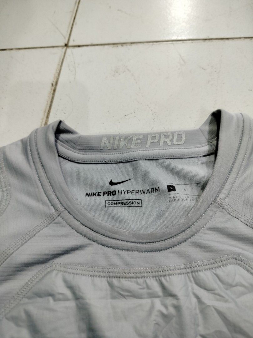 Nike Pro Hyperwarm Compression Shirt Grey Size L (Category: Activewear) located in Manila. Submitted by geraldquinto_917 (Listing ID 1470878462, Image 3). Description: - Brand: Nike Pro - Model: Hyperwarm Compression Long Sleeve Shirt (Style Code: 826699-012) - Color: Grey - Size: Large (L) - Features: Padded quilted chest and shoulder panels with ventilation perforations, Nike Pro branded elastic waistband collar and hem tag - Best for: Cold wea