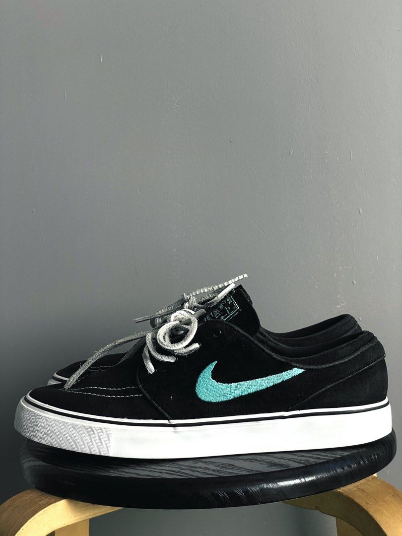 Nike SB Stefan Janoski Black Tiffany (Category: Sneakers) located in Caloocan City. Submitted by ceflores97696 (Listing ID 1470841836, Image 2). Description: - Model: Nike Stefan Janoski skate shoes - Upper: Black suede with vibrant turquoise embroidered swoosh - Details: Signature teal tongue label, clean stitching, and grey leather laces included - Sole: White vulcanized midsole with black outsole offering solid grip - Condition: Minimal wear o