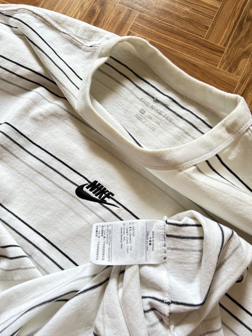 Nike Striped T-Shirt (Category: Tshirts & Polo Shirts ) located in San Fernando. Submitted by erison.cruz26 (Listing ID 1470819640, Image 3). Description: - Brand: Nike - Design: White with black & grey horizontal stripes, embroidered chest logo - Size: XXL (Regular fit) - Material: 100% Cotton (Made in China) - Condition: Brand new / Excellent - Style: Crew neck, short sleeves, easy casual wear -DIMENSION: 23*29.