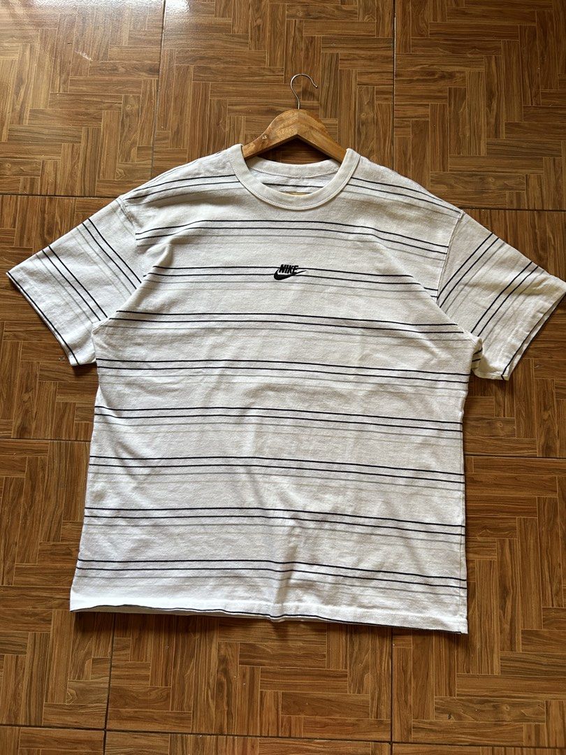 Nike Striped T-Shirt (Category: Tshirts & Polo Shirts ) located in San Fernando. Submitted by erison.cruz26 (Listing ID 1470819640, Image 1). Description: - Brand: Nike - Design: White with black & grey horizontal stripes, embroidered chest logo - Size: XXL (Regular fit) - Material: 100% Cotton (Made in China) - Condition: Brand new / Excellent - Style: Crew neck, short sleeves, easy casual wear -DIMENSION: 23*29.