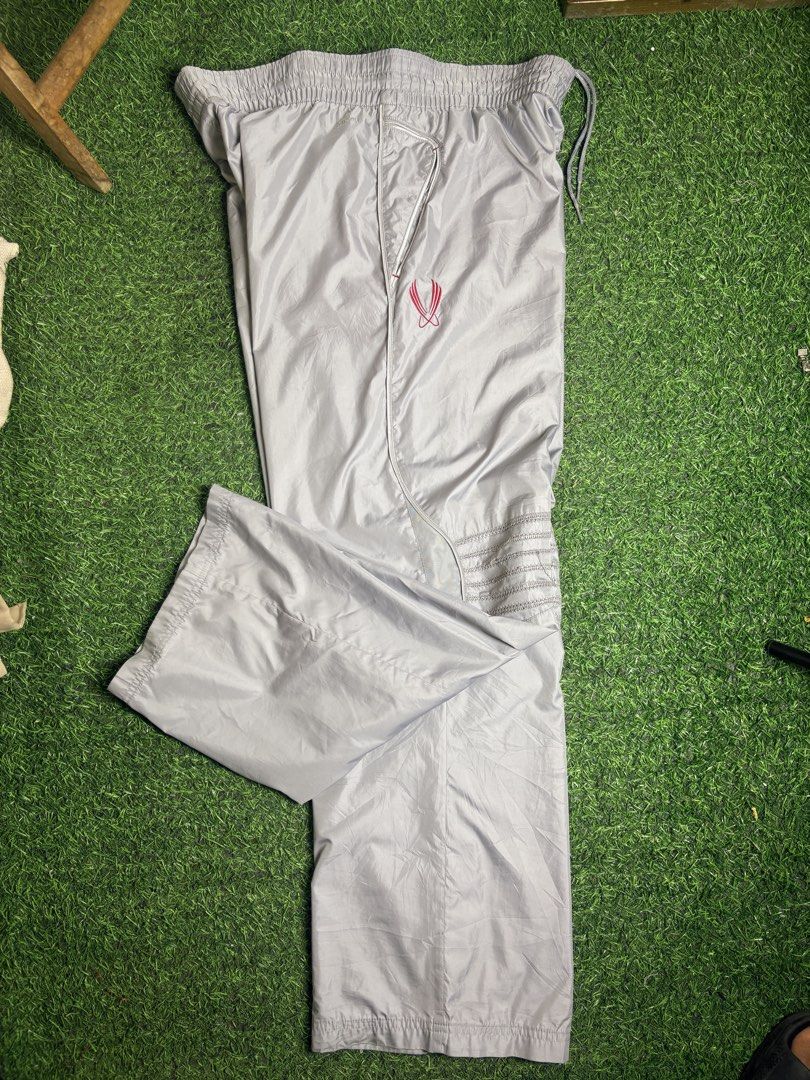 Nike track Pant (Category: Trousers) located in Manila. Submitted by josh2295 (Listing ID 1470764450, Image 2). Description: vintage Y2K-era Nike grey nylon track pants featuring an embroidered red Swoosh logo and panel detailing. W:38-40 L:41 LH:10.