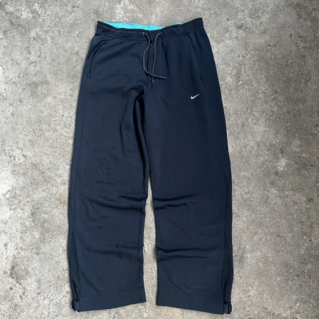 Nike Training Track Pants Black Teal Drawstring (Category: Joggers) located in Caloocan City. Submitted by fairfits (Listing ID 1470792113, Image 1). Description: - Brand: Nike - Color: Black with teal accents and inner waistband - Fit: Secure drawstring closure and adjustable buckle cuffs at the hems - Pockets: Convenient zippered pockets on the sides - Condition: Good overall, with a small damage spot near the lower left leg (refer to pictures)