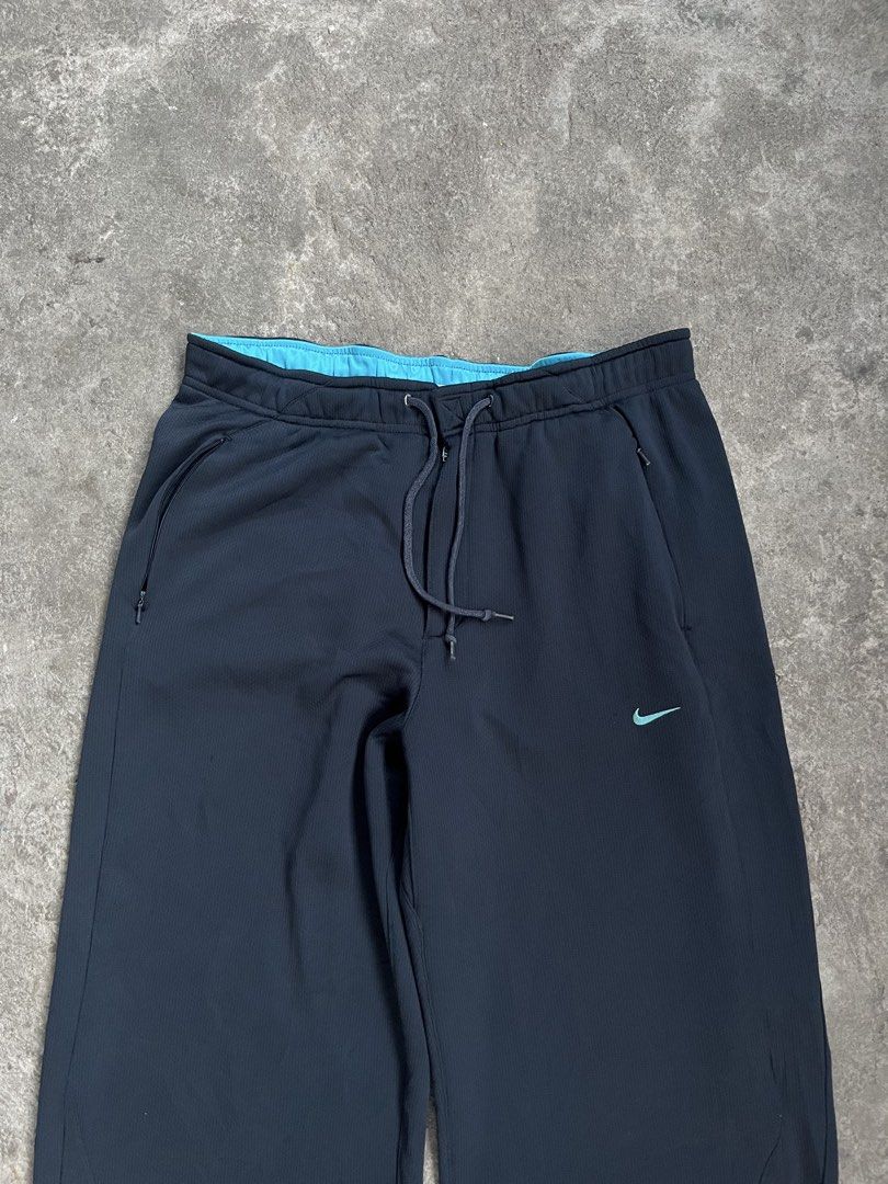 Nike Training Track Pants Black Teal Drawstring (Category: Joggers) located in Caloocan City. Submitted by fairfits (Listing ID 1470792113, Image 2). Description: - Brand: Nike - Color: Black with teal accents and inner waistband - Fit: Secure drawstring closure and adjustable buckle cuffs at the hems - Pockets: Convenient zippered pockets on the sides - Condition: Good overall, with a small damage spot near the lower left leg (refer to pictures)