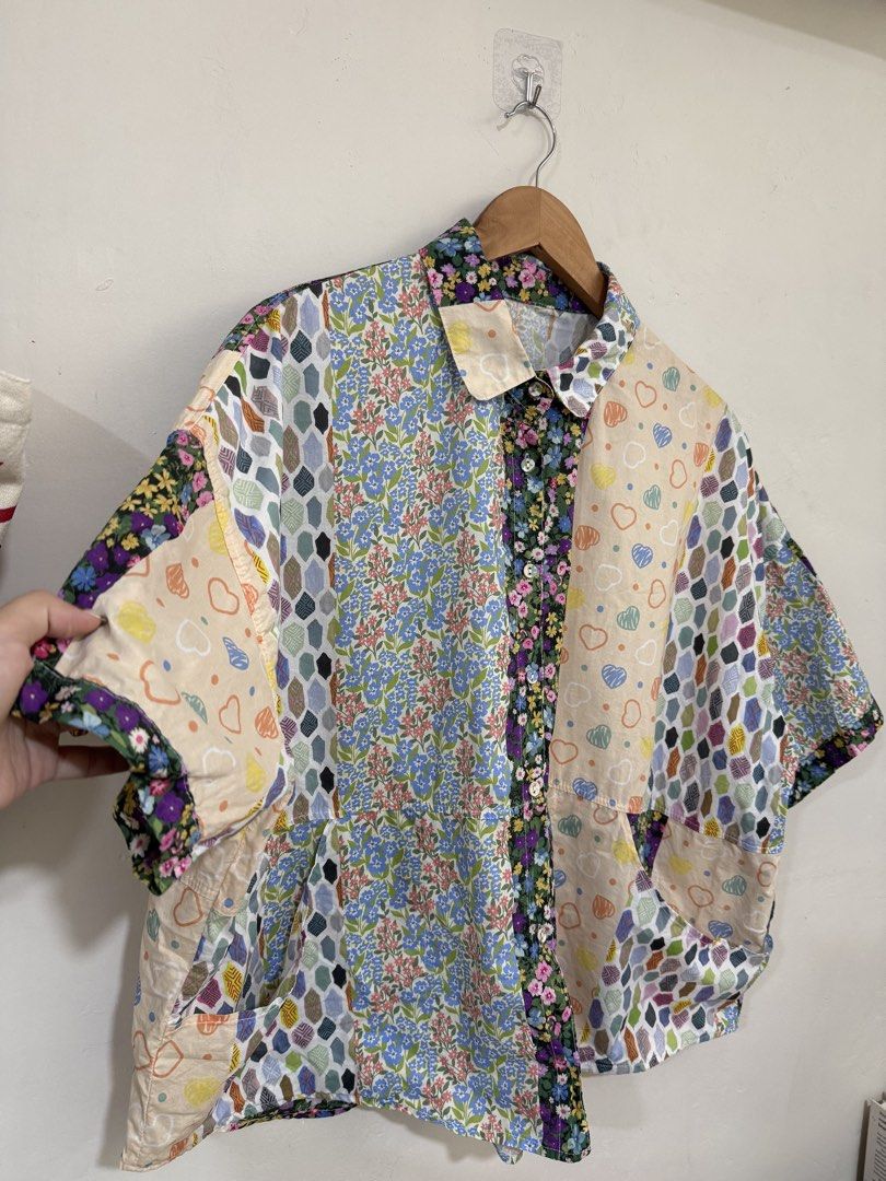 Niko And Oversized Patchwork Buttoned Top (Category: Blouses) located in Manila. Submitted by morningthrifters (Listing ID 1470852562, Image 3). Description: 📝This top is a niko and ... mixed patchwork pattern button-down shirt, heavily featuring a combination of vibrant floral panels, geometric diamond shapes, and a pastel doodle-heart print. Known for its oversized, relaxed Japanese streetwear silhouette, this boxy short-sleeve top combines a 