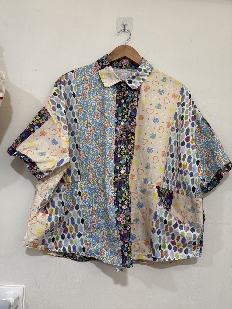 Niko And Oversized Patchwork Buttoned Top (Category: Blouses) located in Manila. Submitted by morningthrifters (Listing ID 1470852562, Image 2). Description: 📝This top is a niko and ... mixed patchwork pattern button-down shirt, heavily featuring a combination of vibrant floral panels, geometric diamond shapes, and a pastel doodle-heart print. Known for its oversized, relaxed Japanese streetwear silhouette, this boxy short-sleeve top combines a 