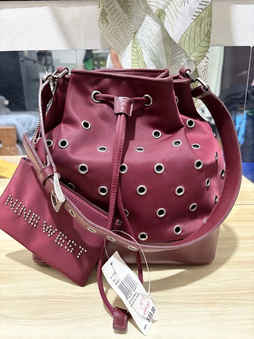 NINE WEST BUCKET BAG (Category: Shoulder Bags) located in Quezon City. Submitted by closetavenue (Listing ID 1470851298, Image 1). Description: •Elegant maroon/wine color • bucket bag with eyelet details • With detachable long strap • Includes matching pouch 🏷️ Brand New / With Tag Perfect for everyday use, office, or casual outfit. Classy and spacious easy to pair with different looks! .