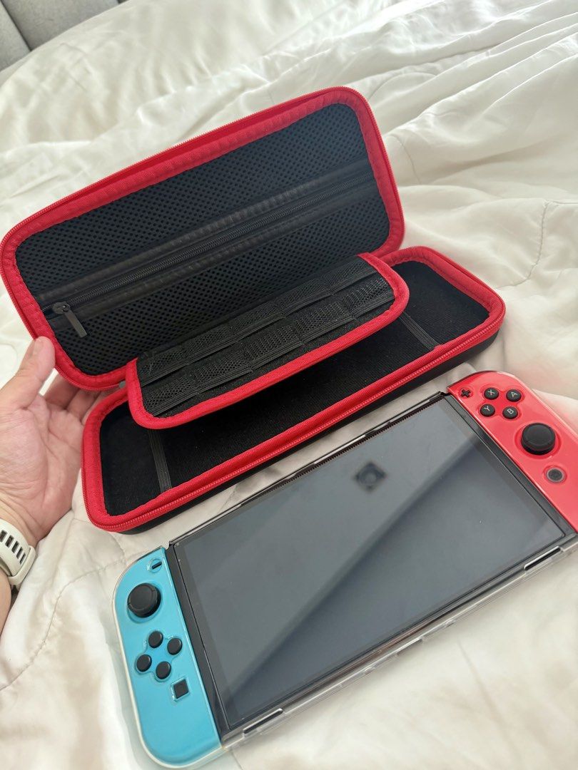 Nintendo Switch OLED – 64GB (Category: Nintendo) located in Pasig City. Submitted by hellolala.94 (Listing ID 1470857549, Image 3). Description: Nintendo Switch OLED – 64GB | Neon Red & Blue Selling our pre-loved Nintendo Switch OLED screen * 64GB internal storage * Neon Red & Blue Joy-Con controllers * With protective clear case and carrying case * In good used condition * Working and ready to play.