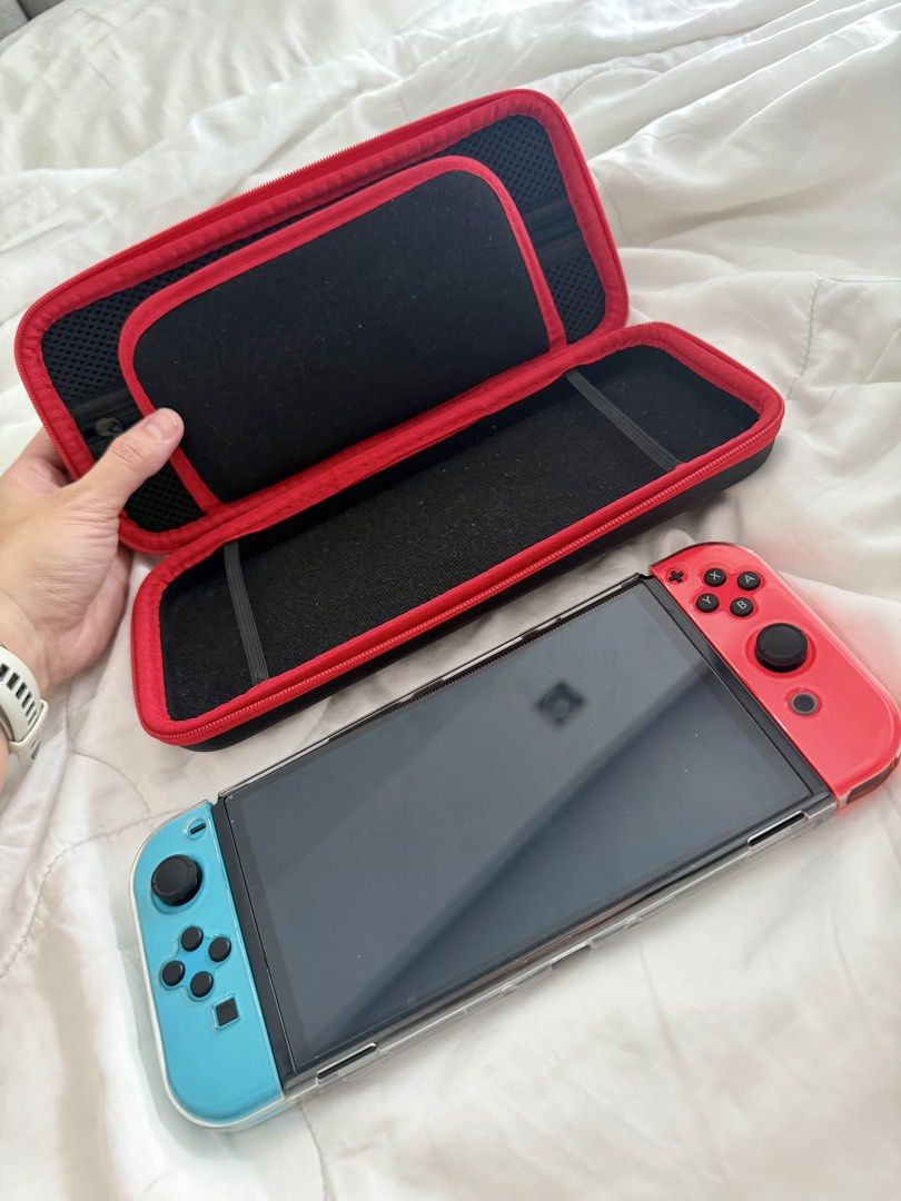 Nintendo Switch OLED – 64GB (Category: Nintendo) located in Pasig City. Submitted by hellolala.94 (Listing ID 1470857549, Image 2). Description: Nintendo Switch OLED – 64GB | Neon Red & Blue Selling our pre-loved Nintendo Switch OLED screen * 64GB internal storage * Neon Red & Blue Joy-Con controllers * With protective clear case and carrying case * In good used condition * Working and ready to play.