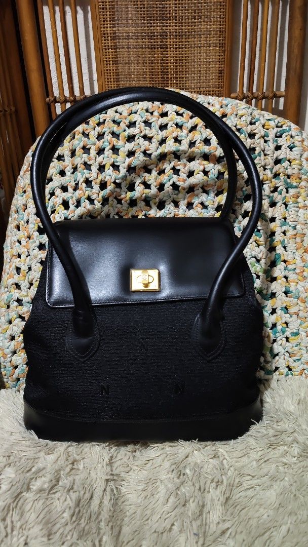 Nobuo collection...Black structured shoulder bag with gold turn-lock closure (Category: Shoulder Bags) located in Cebu City. Submitted by lumaynojes00490 (Listing ID 1470828098, Image 1). Description: - Color: Classic black - Material: Textured fabric body with smooth leather flap and trim - Design: Subtle embroidered 'N' pattern with clean lines - Hardware: Elegant gold-tone square turn-lock closure - Straps: Two long, rounded shoulder straps fo