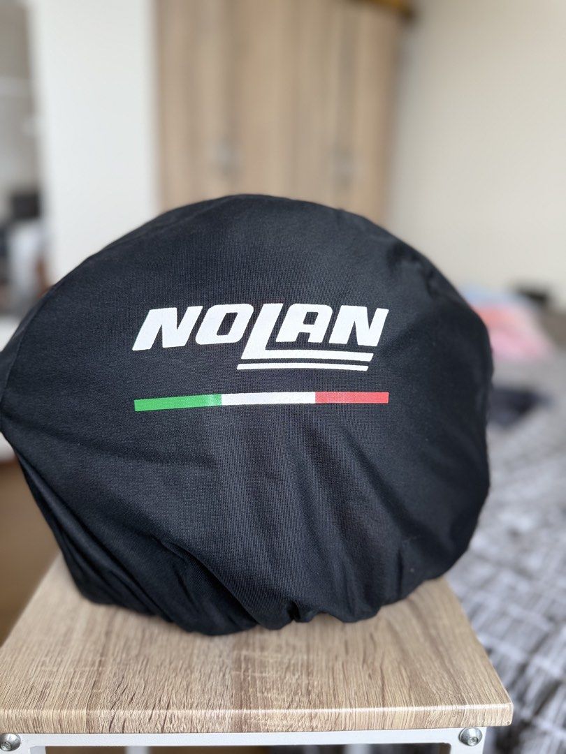 Nolan motorcycle helmet lexan polycarbonate size M (Category: Caps & Hats) located in Pasig City. Submitted by sherill888 (Listing ID 1470795012, Image 2). Description: - Brand/Model: Nolan Full Face Motorcycle Helmet - Design: Bold black, red, and white graphics - Visor: Clear visor currently installed - Condition: Impeccably clean inside and out - Inclusions: Original Nolan black fabric storage bag with Italian flag stripe design - Status: Road