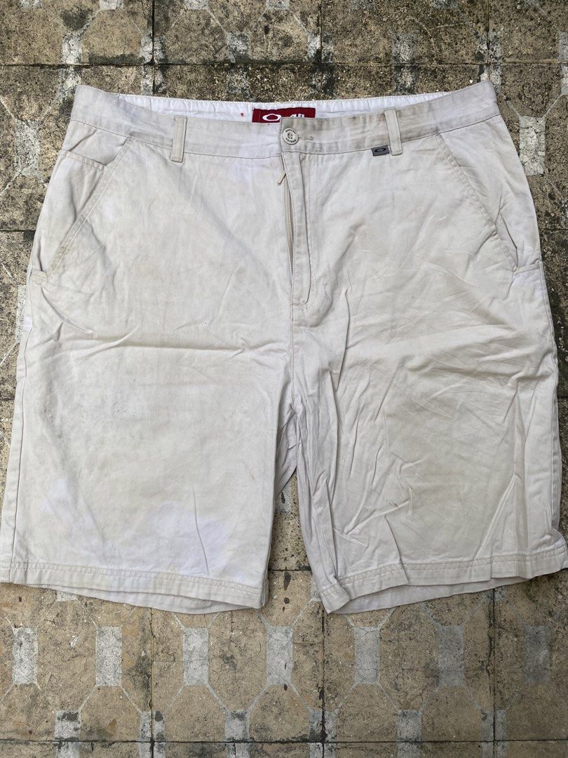 Oakley Tan Casual Shorts Size 40 (Category: Shorts) located in Imus. Submitted by frootiloots4103 (Listing ID 1470768340, Image 1). Description: - Brand: Oakley - Color: Cream / Light Tan - Size: 40 waist (Length: 23", Inseam: 13" based on tag) - Material: 100% Cotton - Details: Button closure with zipper fly, back pocket, branded Oakley hardware - Origin: Made in Macau - Condition: Pre-loved with some visible staining on the fabric OPEN FOR NEGO