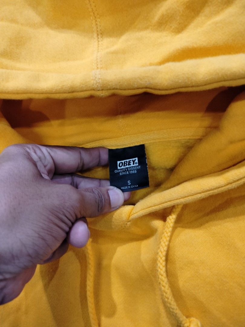 Obey Yellow Box Face Hoodie Size S (Category: Coats, Jackets and Outerwear) located in Manila. Submitted by geraldquinto_917 (Listing ID 1470878592, Image 2). Description: - Brand: Obey - Color: Bright yellow - Design: Classic box face logo graphic on chest - Size: S - Material: 80% cotton, 20% polyester blend - Features: Drawstring hood, front kangaroo pocket, ribbed cuffs and hem - Condition: Clean, vibrant color, ready to wear.