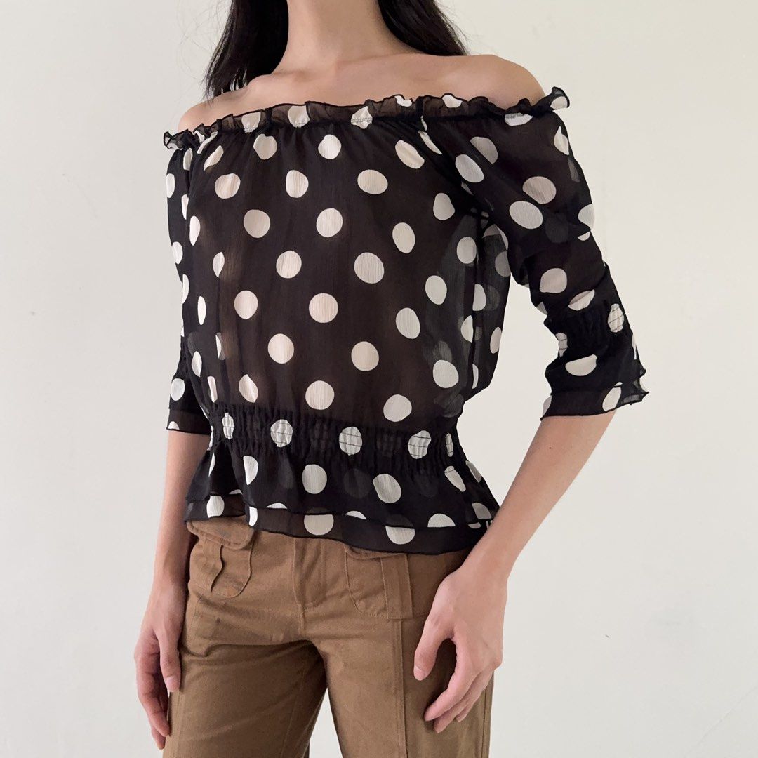 Off Shoulder Sheer Black White Polka Dot Blouse (Category: Blouses) located in Calamba. Submitted by quietarchive (Listing ID 1470820109, Image 1). Description: - Brand: One Way (Japanese brand tag attached) - Fits S-M - Design: Black with large white polka dots - Neckline: Off-shoulder with ruffled trim - Sleeves: Three-quarter with elastic cuffs - Waist: Smocked elastic peplum shape - Fabric: Lightweight and sheer.