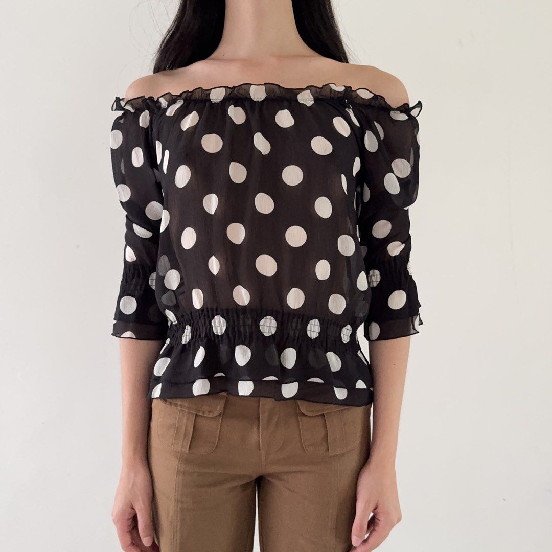 Off Shoulder Sheer Black White Polka Dot Blouse (Category: Blouses) located in Calamba. Submitted by quietarchive (Listing ID 1470820109, Image 3). Description: - Brand: One Way (Japanese brand tag attached) - Fits S-M - Design: Black with large white polka dots - Neckline: Off-shoulder with ruffled trim - Sleeves: Three-quarter with elastic cuffs - Waist: Smocked elastic peplum shape - Fabric: Lightweight and sheer.
