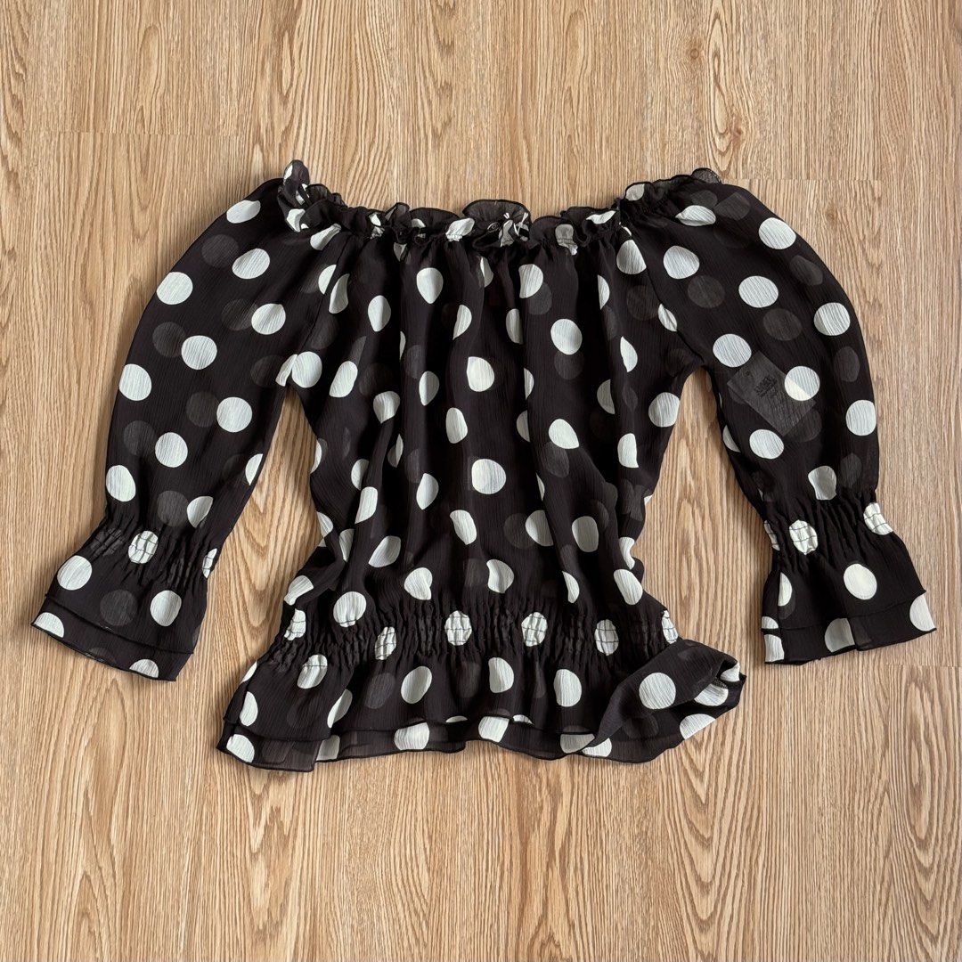 Off Shoulder Sheer Black White Polka Dot Blouse (Category: Blouses) located in Calamba. Submitted by quietarchive (Listing ID 1470820109, Image 2). Description: - Brand: One Way (Japanese brand tag attached) - Fits S-M - Design: Black with large white polka dots - Neckline: Off-shoulder with ruffled trim - Sleeves: Three-quarter with elastic cuffs - Waist: Smocked elastic peplum shape - Fabric: Lightweight and sheer.