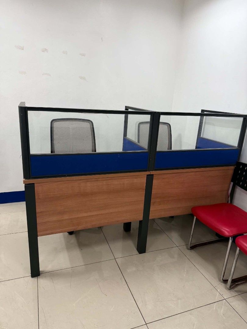 Office cubicle workstations with blue partitions and chairs (Category: Office Furniture & Fixtures) located in Quezon City. Submitted by kuruma_13 (Listing ID 1470748953, Image 1). Description: - Complete cubicle workstation setup with sturdy metal frames - Features wooden base panels, blue dividers, and glass top screens - Includes comfortable matching office chairs with armrests and mesh/upholstered backs - Ideal for small team workspaces or ho