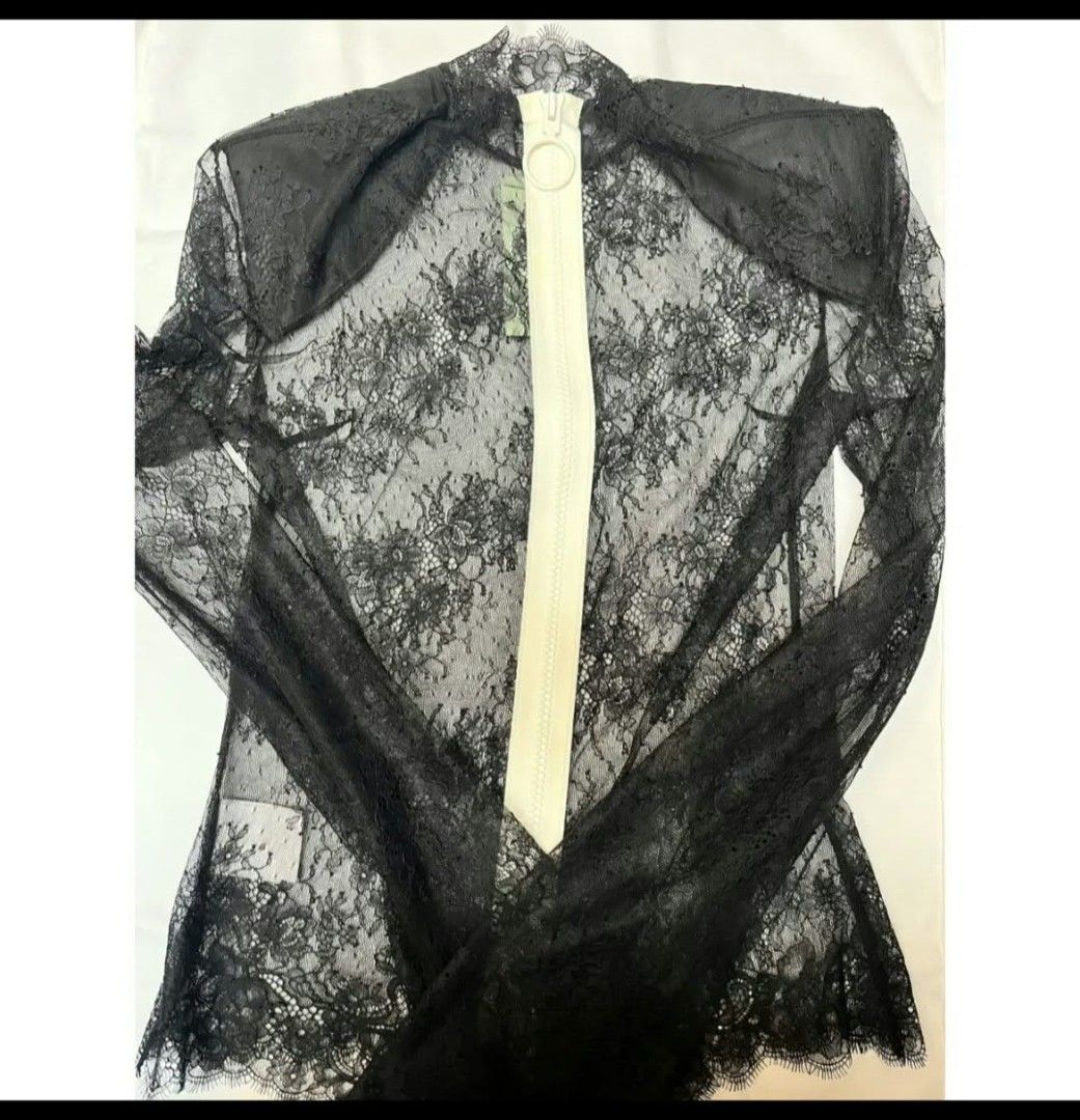 Off-White Black Lace Long Sleeve Zip Top (Category: Luxury Apparel) located in Paranaque City. Submitted by calm_youngstore7 (Listing ID 1470747843, Image 3). Description: 80% OFF RETAIL! LAST PICE SALE! - Brand: Off-White - Color: Black with white zip detail - Material: Sheer floral lace - Features: Long sleeves, prominent white front zipper - Condition: Brand new with original tags attached - Measurements: 16 inches across chest, 25 inches in l
