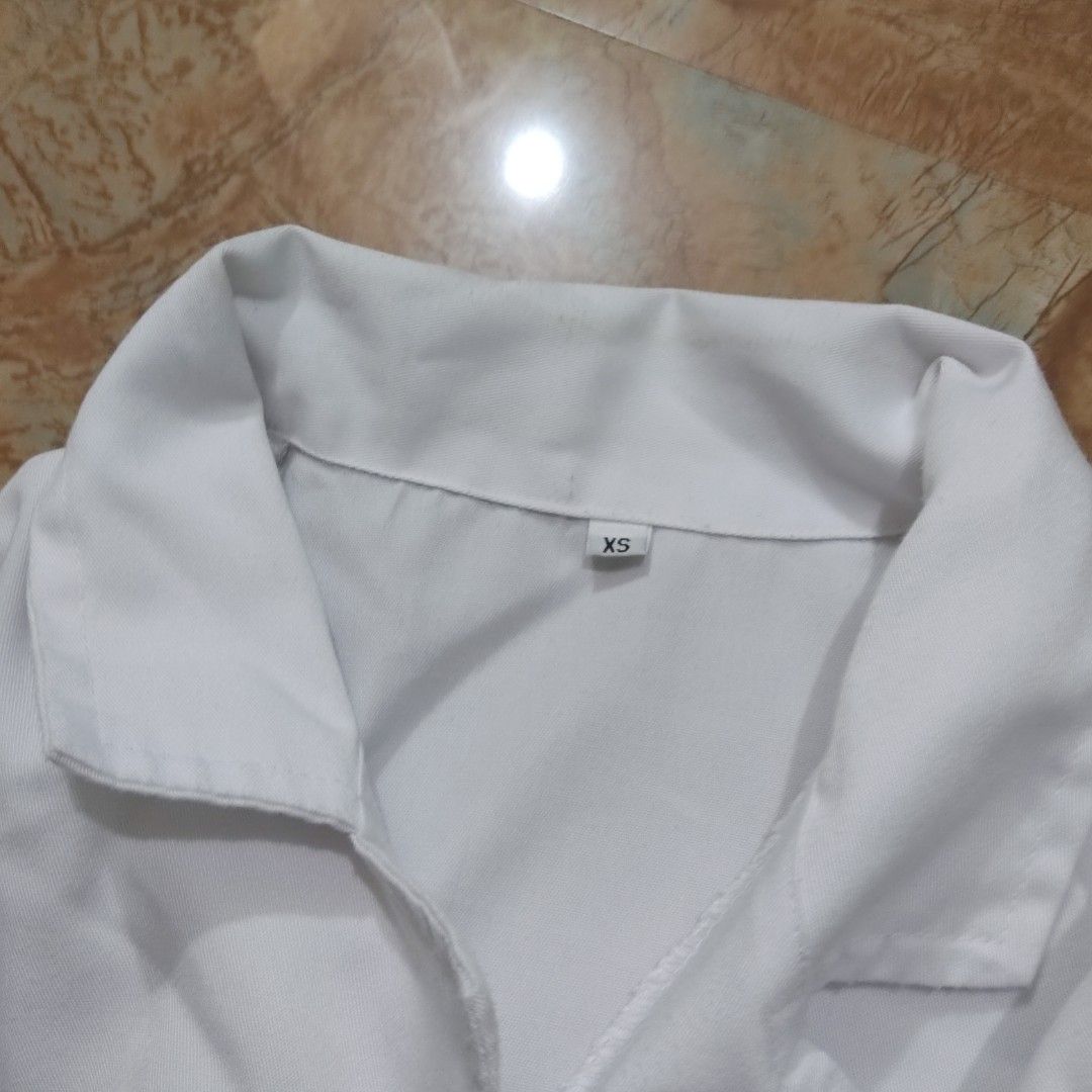 OLFU Medtech Lab Gown | XS (Category: Coats, Jackets and Outerwear) located in Valenzuela. Submitted by 0003c4 (Listing ID 1470856744, Image 3). Description: white lab gown with long sleeves and front buttons Size XS, features front pockets and elastic cuffs Preloved; has minor visible marks/stains (see photos) location Valenzuela or Malabon mod lalamove or jnt.