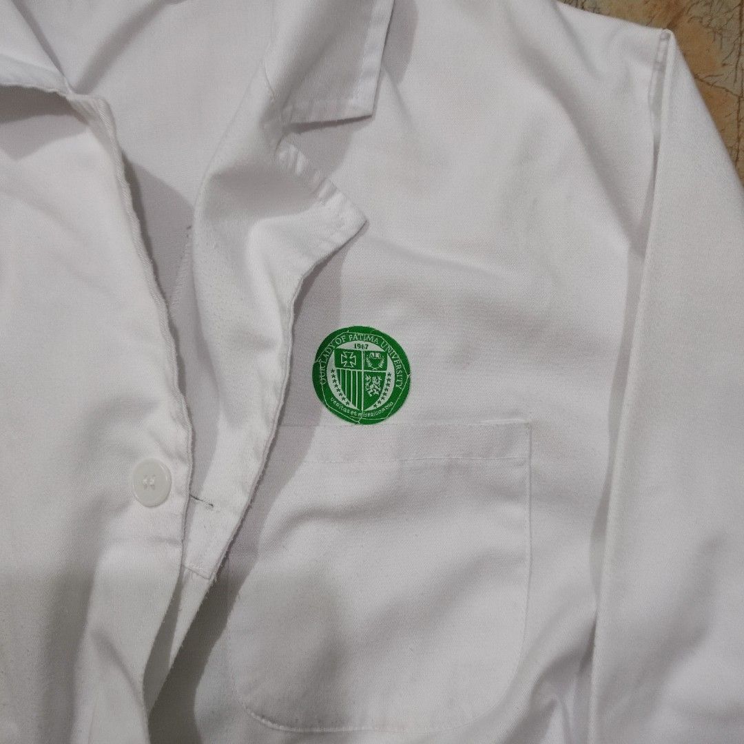 OLFU Medtech Lab Gown | XS (Category: Coats, Jackets and Outerwear) located in Valenzuela. Submitted by 0003c4 (Listing ID 1470856744, Image 2). Description: white lab gown with long sleeves and front buttons Size XS, features front pockets and elastic cuffs Preloved; has minor visible marks/stains (see photos) location Valenzuela or Malabon mod lalamove or jnt.