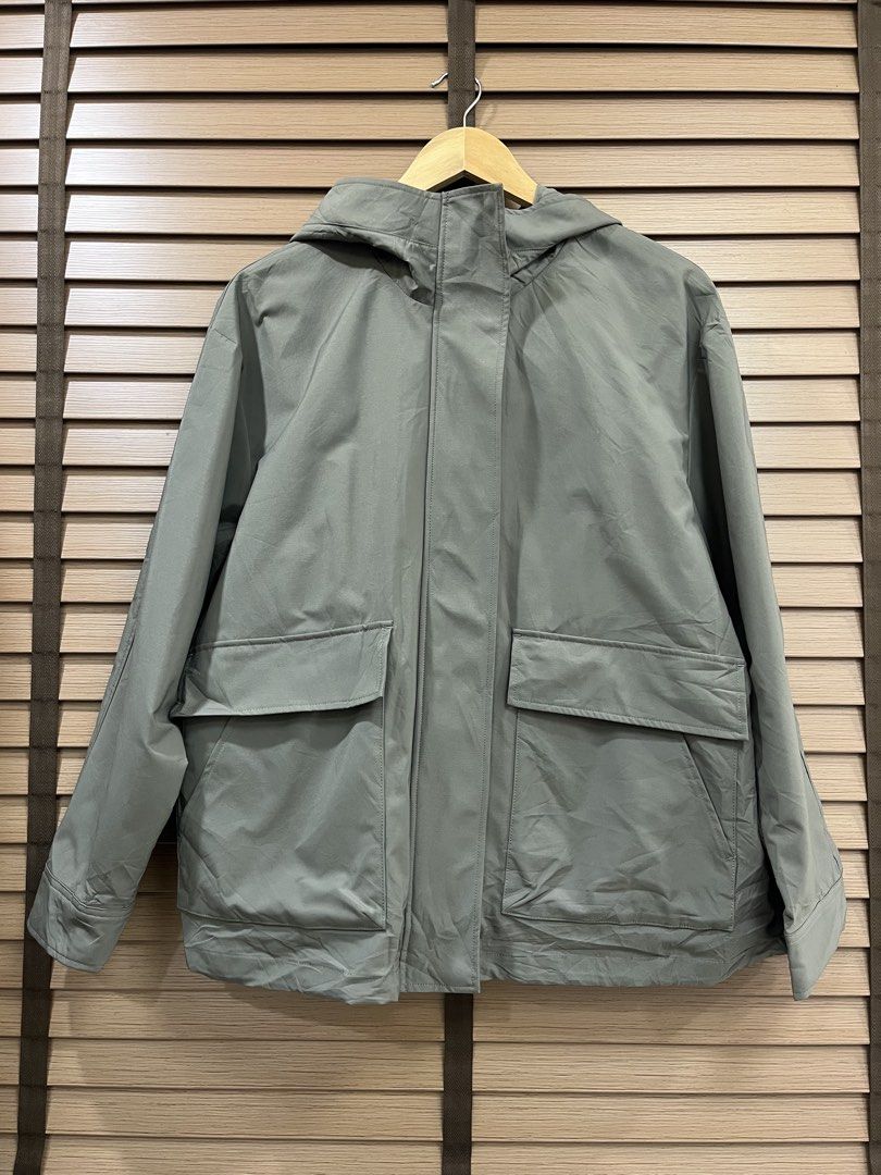 Olive Green Hooded Utility Jacket with Front Pockets (Category: Coats, Jackets and Outerwear) located in Mabalacat. Submitted by fashionclothesph (Listing ID 1470845630, Image 1). Description: - Color: Trendy olive green - Width 22inches - Length 27inches - Style: Lightweight hooded utility jacket with a loose fit - Closure: Full zip front with a snap-button storm flap - Pockets: Two large front flap pockets plus convenient side hand pockets - Pe